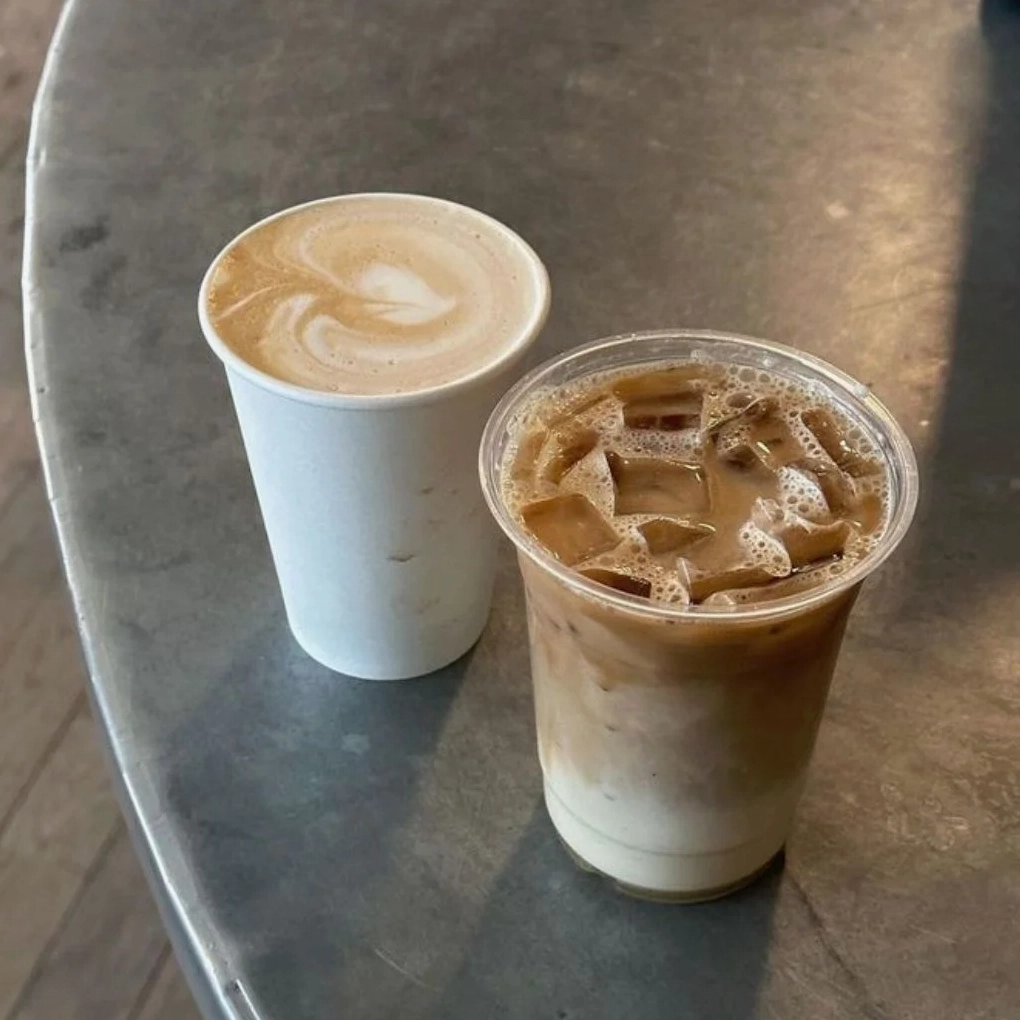 Ly cà phê sữa đá đặt cạnh cửa sổ đón nắng ấm áp